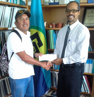 CRFM Executive Director, Milton Haughton, presents reward to Outstanding Fisher of the Year, Cesar Mu&ntilde;oz