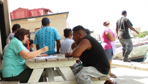 Claudia Stella Beltrán Turriago, economic consultant, interviewing fishers at Northern Fishermen&#039;s Cooperative in Belize City, Belize